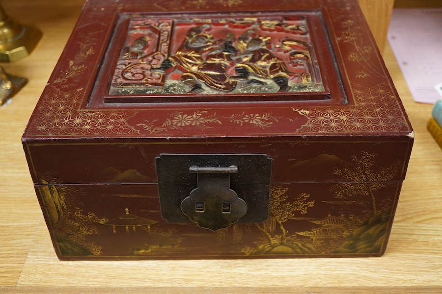 A Chinese lacquered box decorated with relief figures, 33cm wide